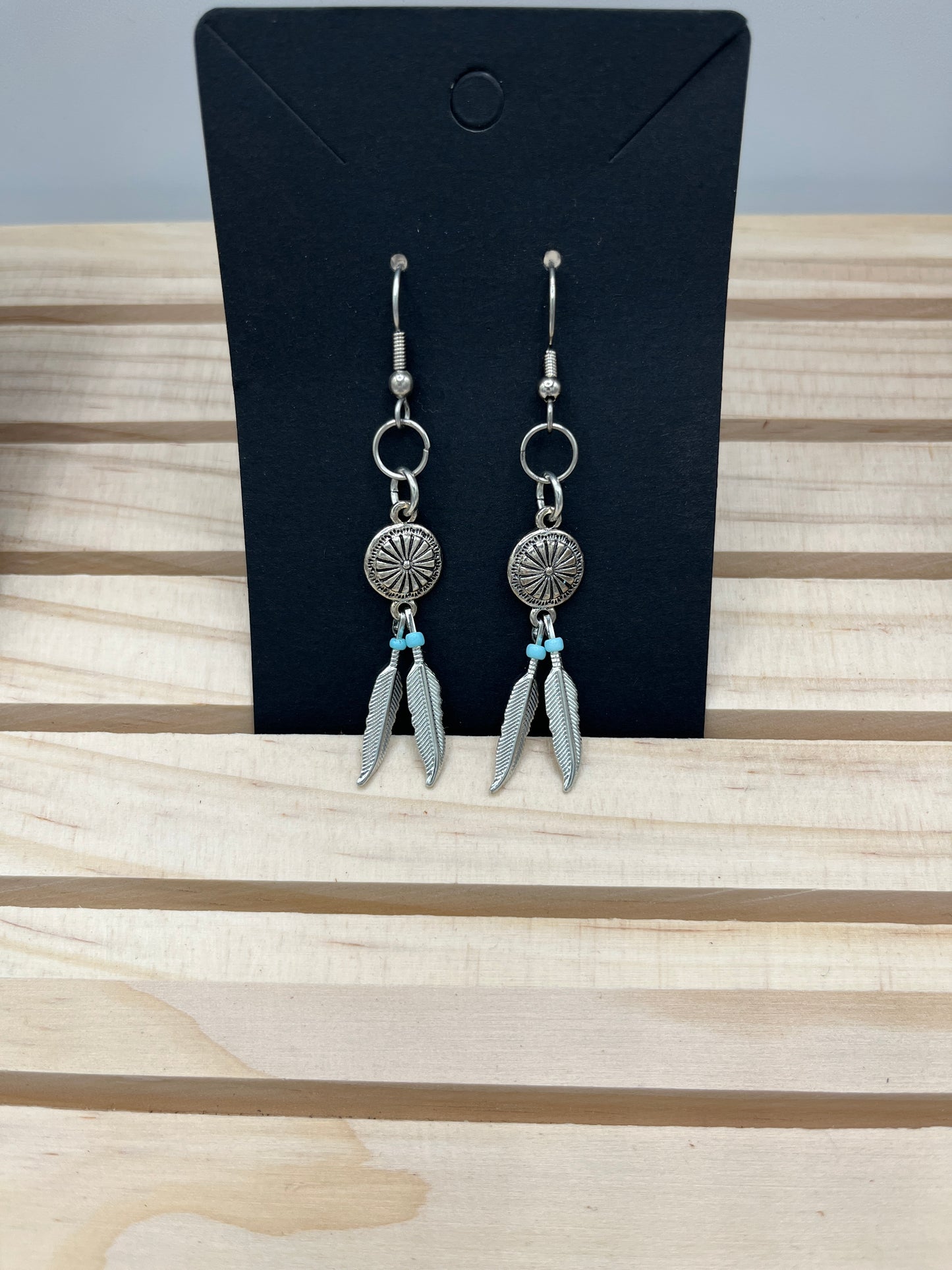 Silver plated medallion with feathers earrings