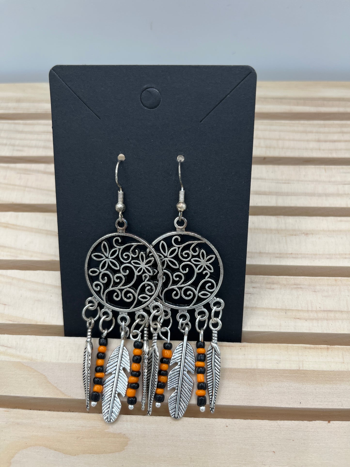Dreamcatcher with floral center and orange and black bead earrings