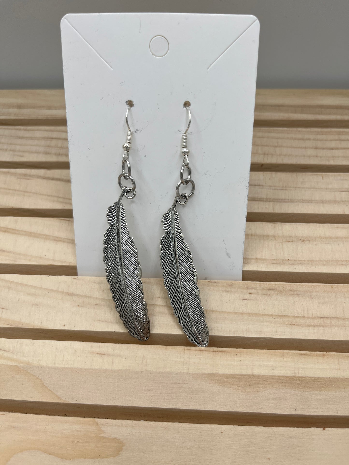 Silver curved feathers