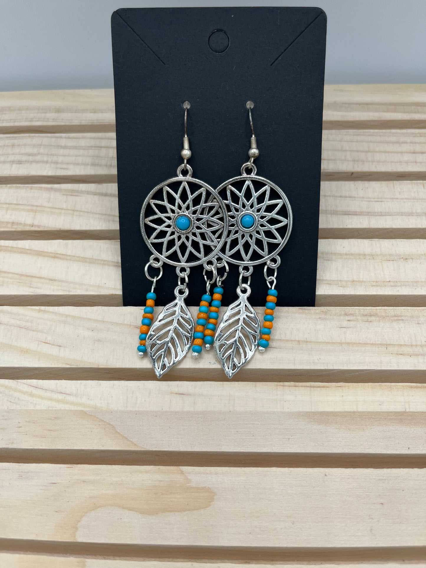 Dreamcatcher earrings with sunburst and orange and teal beads