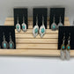 Long Silver tone feather with teardrop turquoise set earrings